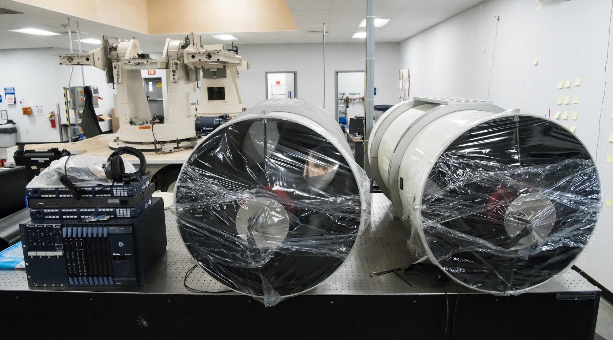 Telescopes, wrapped for shipping, sit on a table in the Optics Laboratory at Arnold Air Force Base, Tenn., Jan. 13, 2020. The telescopes are part of Joint Standard Instrumentation Suite and mount to the platforms in the background. The equipment is in the Optics Laboratory for further development by the Arnold Engineering Development Complex Test Technology, Analysis and Evaluation Branch. (U.S. Air Force photo by Jill Pickett)