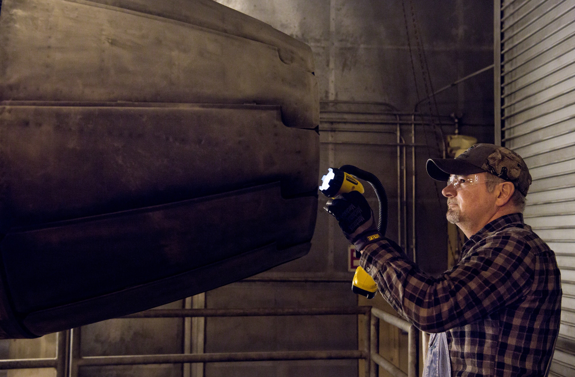 Stan Freeze, outside machinist, inspects the tail of a F404 engine Jan. 10, 2020, in a sea level test cell at Arnold Air Force Base, Tenn.  The engine is being prepared for use as a testbed by the Arnold Engineering Development Complex Technology, Analysis and Evaluation Branch. (U.S. Air Force photo by Jill Pickett)