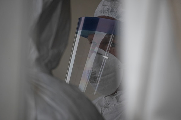 A New Jersey Air National Guard Airman from the 108th Medical Group stands by to assist patients at a COVID-19 Community-Based Testing Site at the PNC Bank Arts Center in Holmdel, N.J., March 23, 2020.  The testing site, established in partnership with the Federal Emergency Management Agency, is staffed by the New Jersey Department of Health, the New Jersey State Police, and the New Jersey National Guard. (U.S. Air National Guard photo by Master Sgt. Matt Hecht)