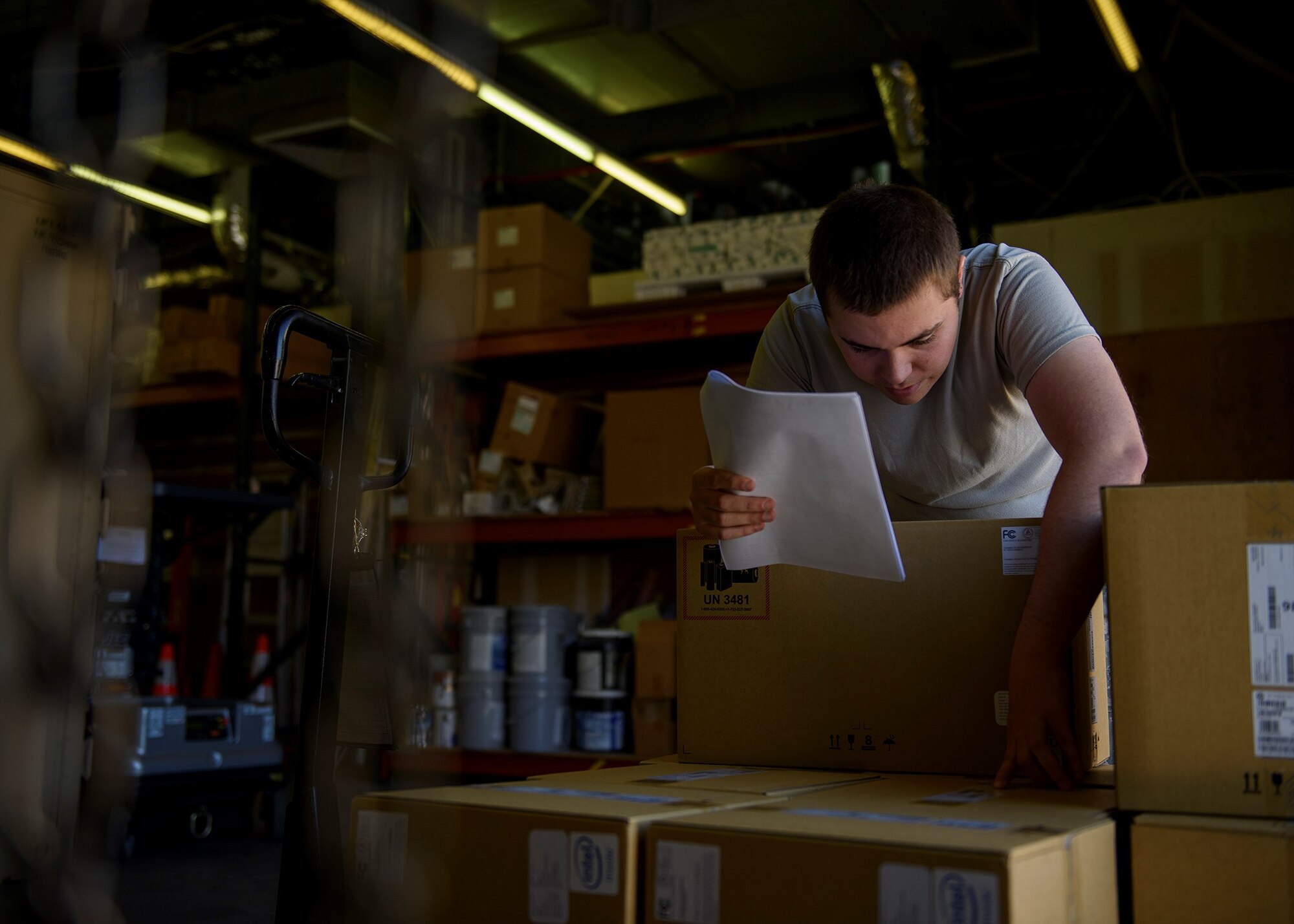 An Airmen looks in a box.