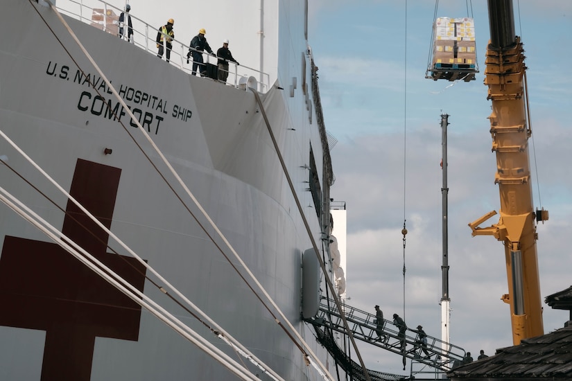 Supplies are loaded onto a ship.