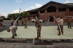 A photo of Airmen connecting support beams.