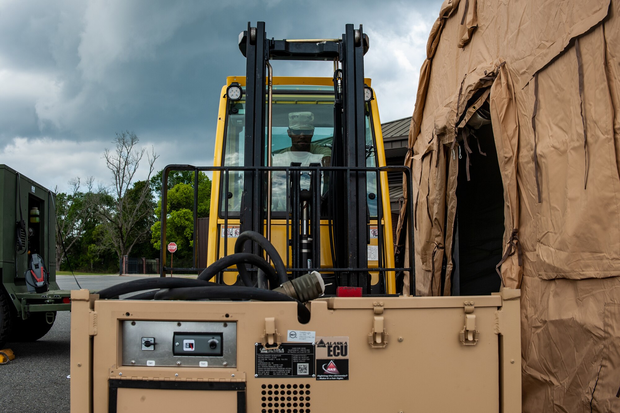 A photo of an Airman operating forklift.