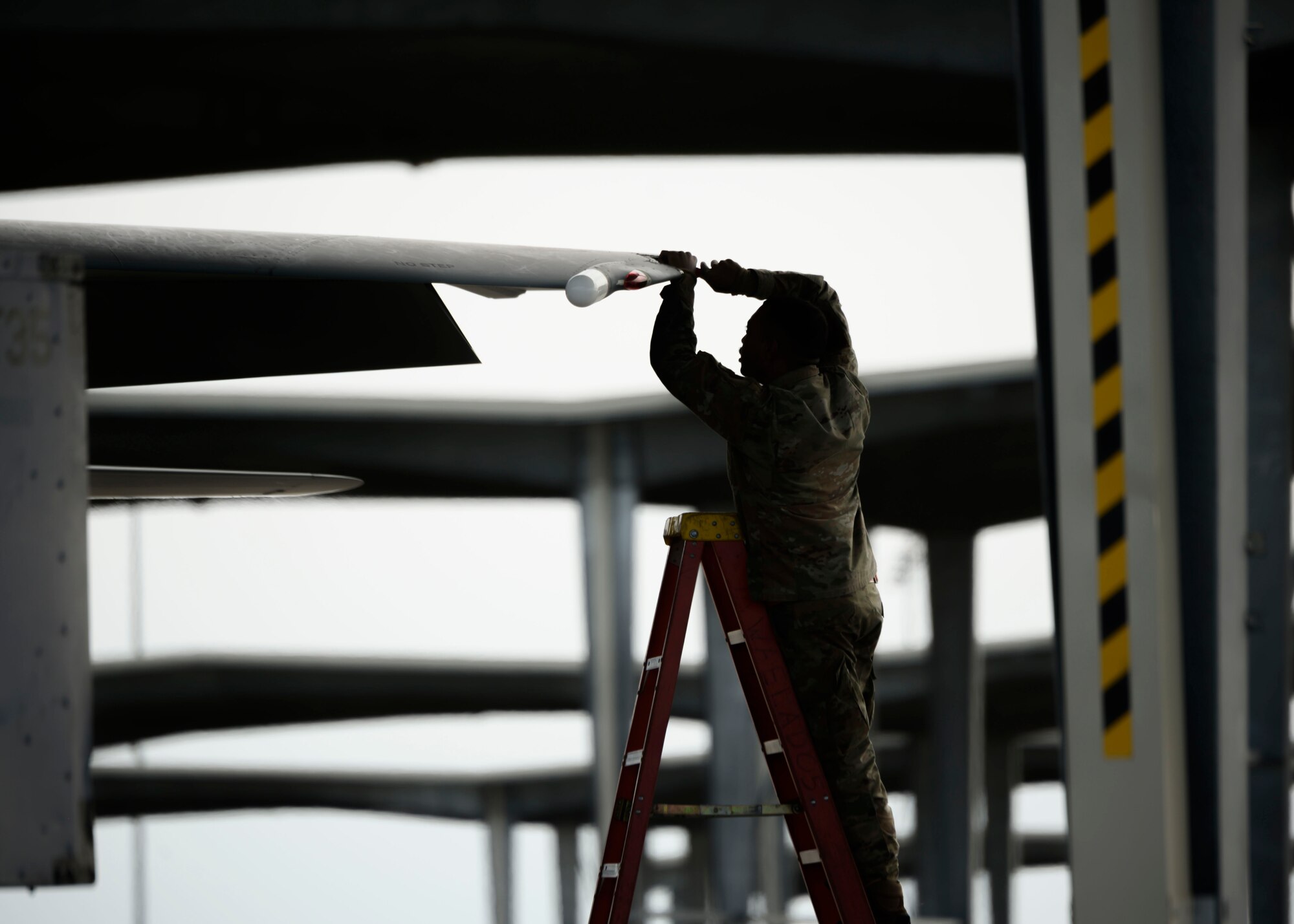 A Maintainer from the 391st Fighter Squadron tends to a wing on an F-15E Strike Eagle from assigned to the 391st Fighter Squadron. The Gunfighters are maintaining their total force efforts in the midst of schedule changes due to COVID-19 (U.S. Air Force photo by Senior Airman Tyrell Hall)