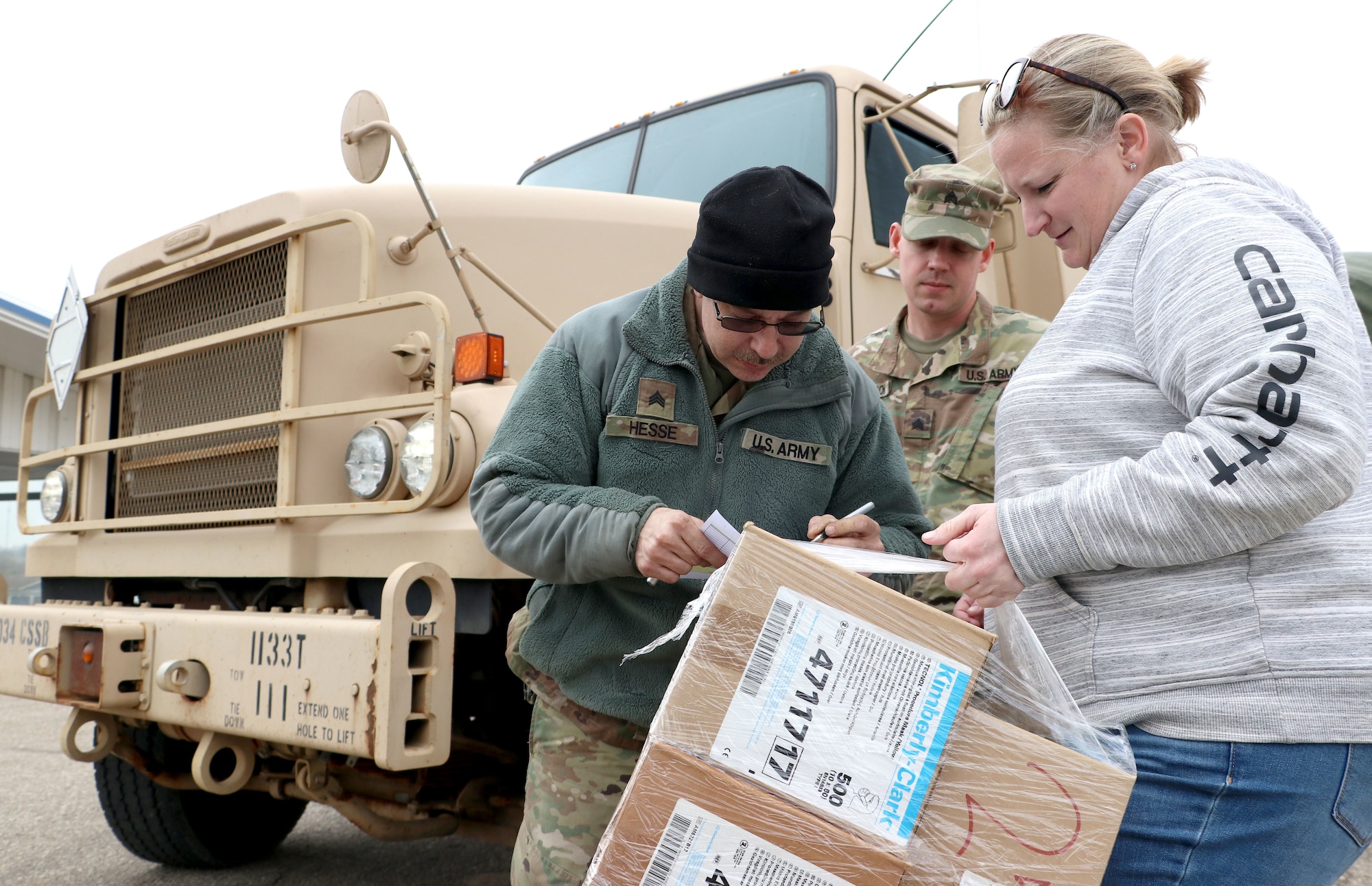 Sgt. Timothy Hesse Sr. and Sgt. Zachary Anderson, motor transport operators with the 1133rd Transportation Company, Iowa Army National Guard, deliver essential medical supplies in Iowa