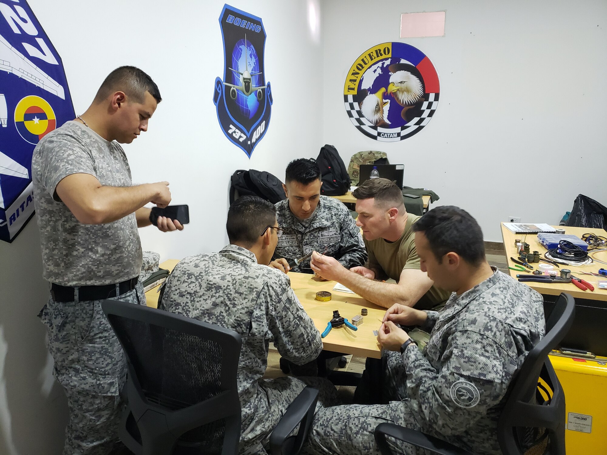 U.S. Air Force Tech. Sgt. Haines, 571st Mobility Support Advisory Squadron maintenance air advisor, shows Colombian Air Force maintainers proper maintenance techniques and electrical system familiarization and troubleshooting during a mobile training team mission, Mar. 5, 2020. Airmen from the 571st MSAS and three other U.S. Air Force units, worked with the Colombian armed forces as part of an MTT from Feb. 11 through Mar. 11 at two air bases in Colombia. (Courtesy Photo)