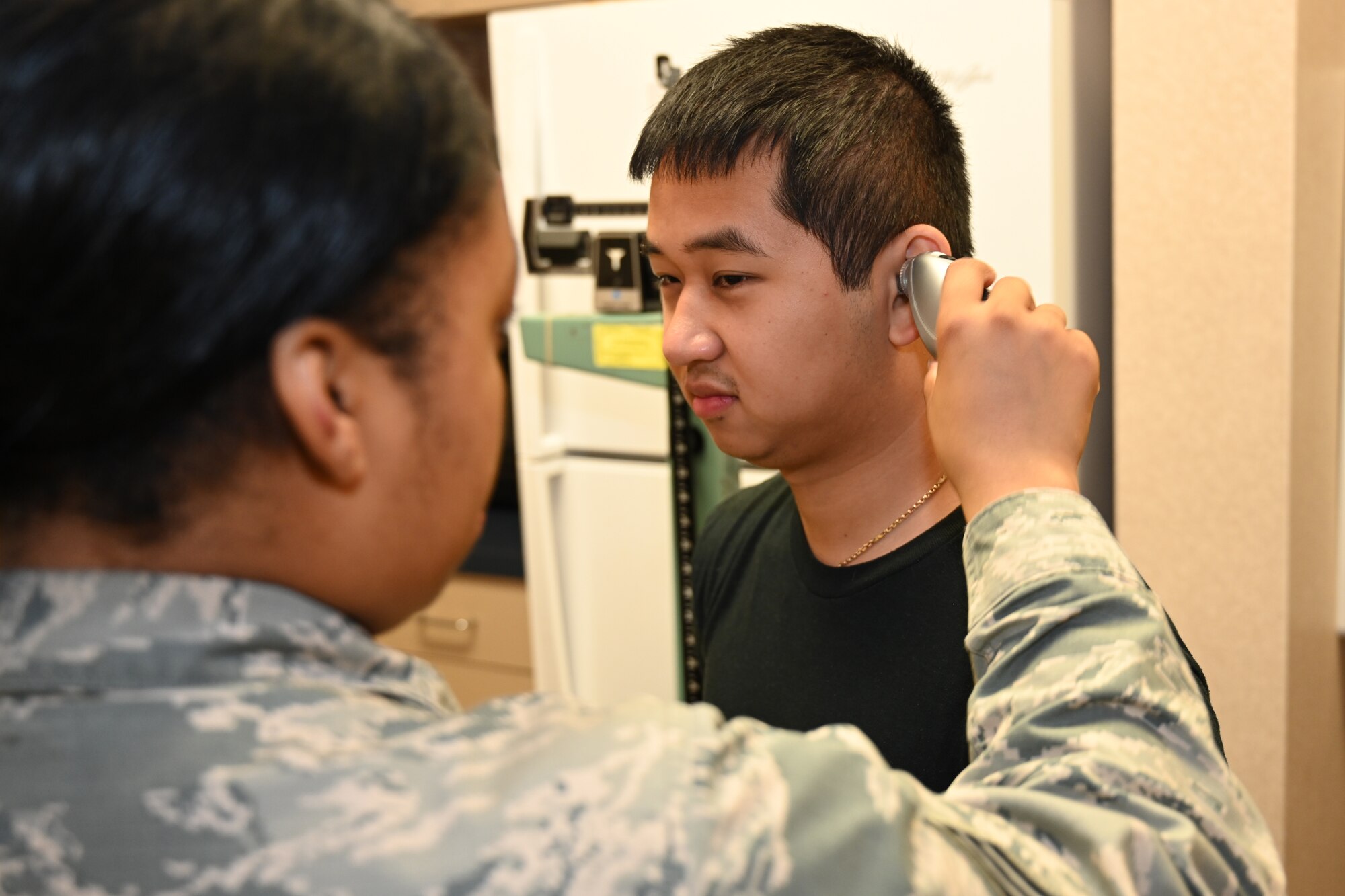 Photo of Airman getting temp taken