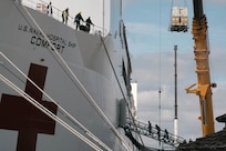 Supplies are loaded onto a ship.