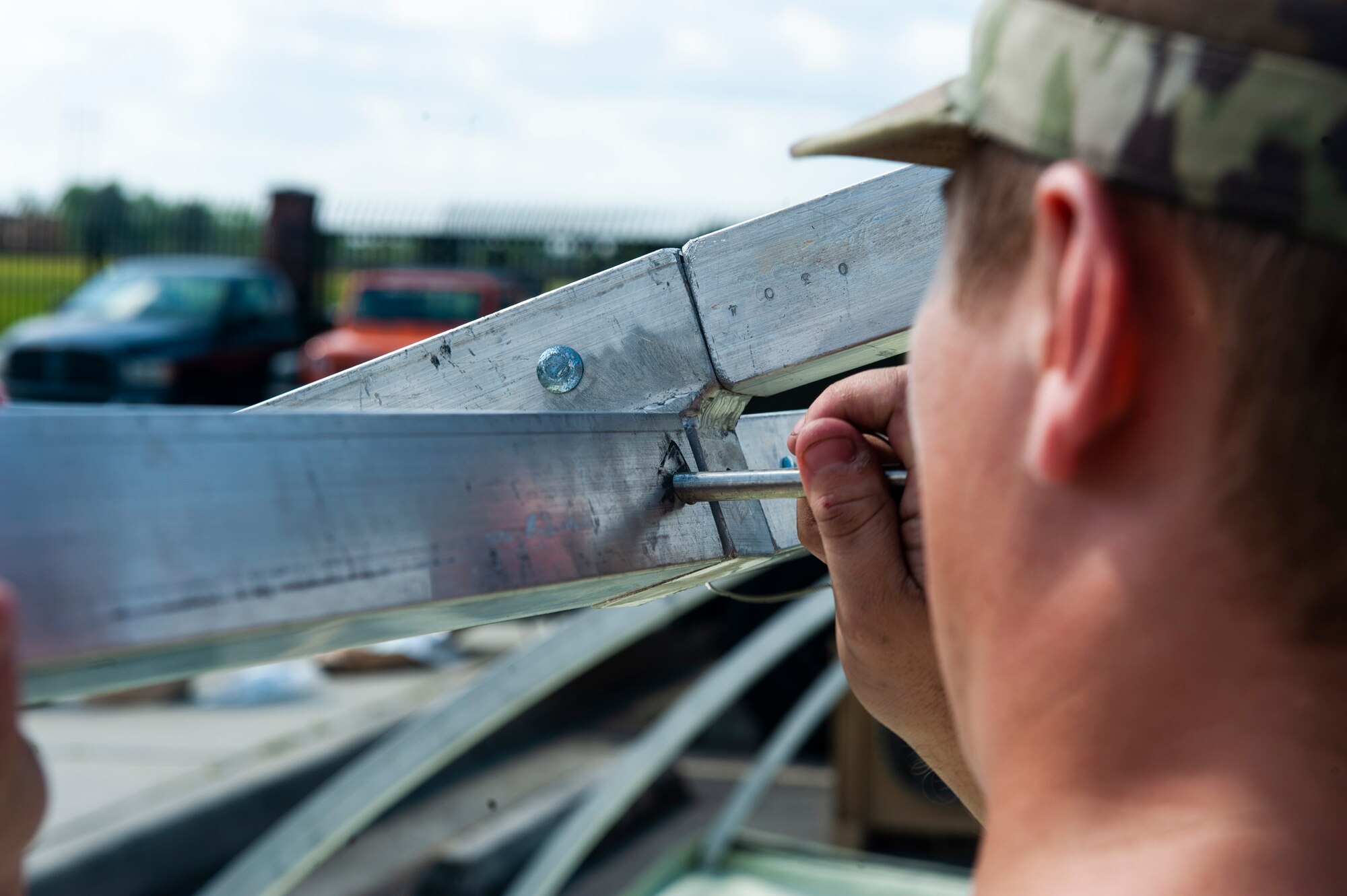 A photo of an Airman pushing a pin.