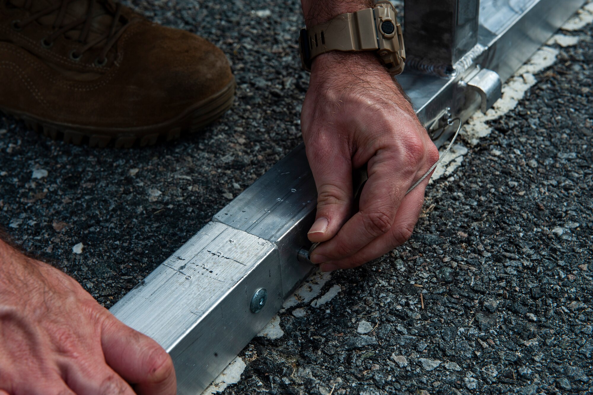 A photo of an Airman connecting tent support rods