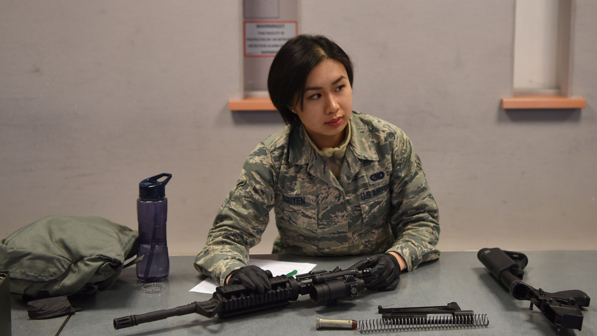 U.S. Air Force Airman Darcy Nguyen, 86th Logistics Readiness Squadron flight service center agent, disassembles an M4 carbine assault rifle during a Combat Arms Training and Maintenance course.
