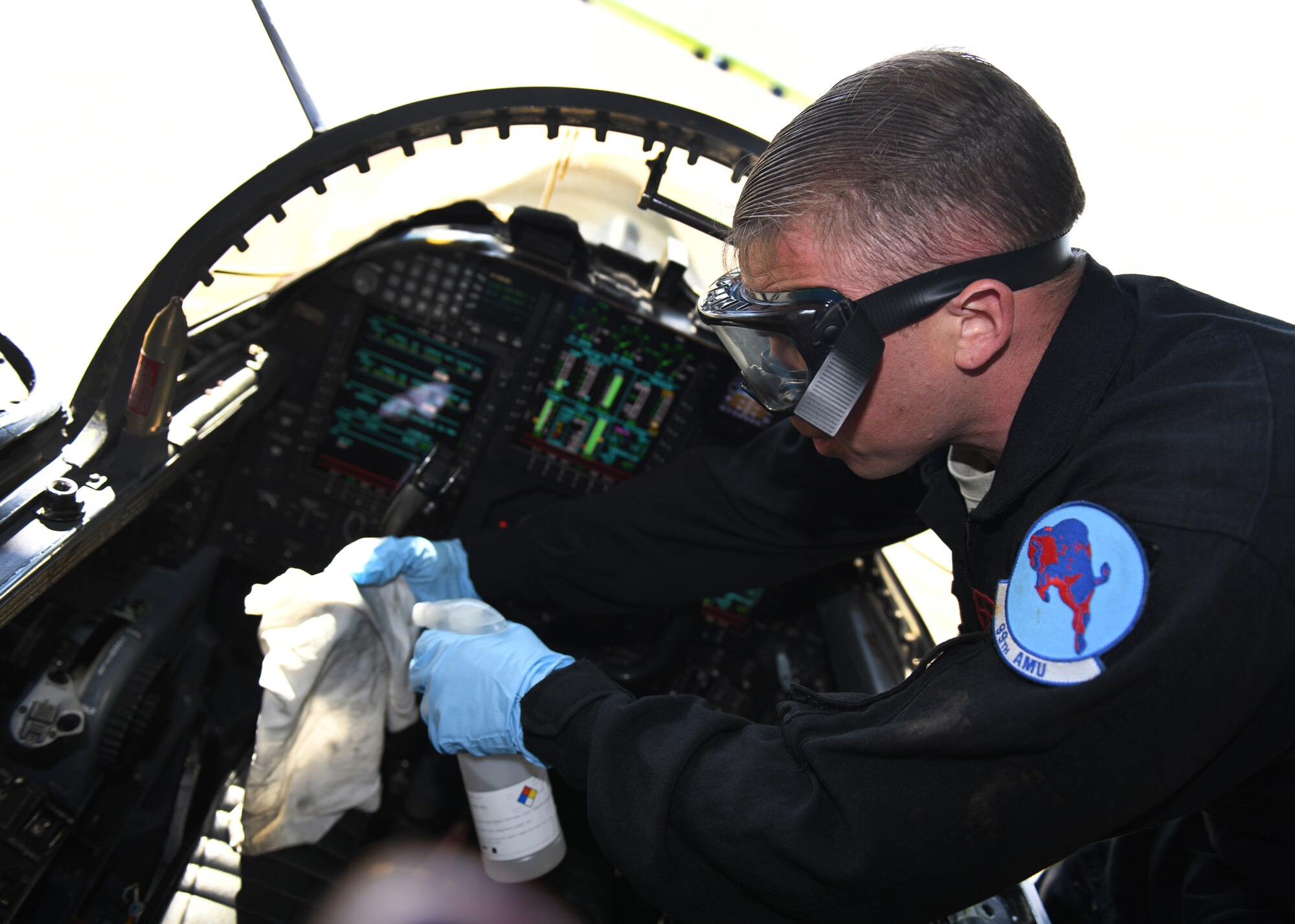 Staff Sgt. Brandon Green, 99th Aircraft Maintenance Unit dedicated crew chief, sprays disinfectant liquid on a rag to sanitize a U-2 Dragon Lady’s cockpit Mar. 23, 2020 at Beale Air Force Base, California. The cockpits on Beale’s fleet of U-2s will be sanitized on a regular basis to prevent the spread of COVID-19. (U.S. Air Force photo by Airman 1st Class Luis A. Ruiz-Vazquez)