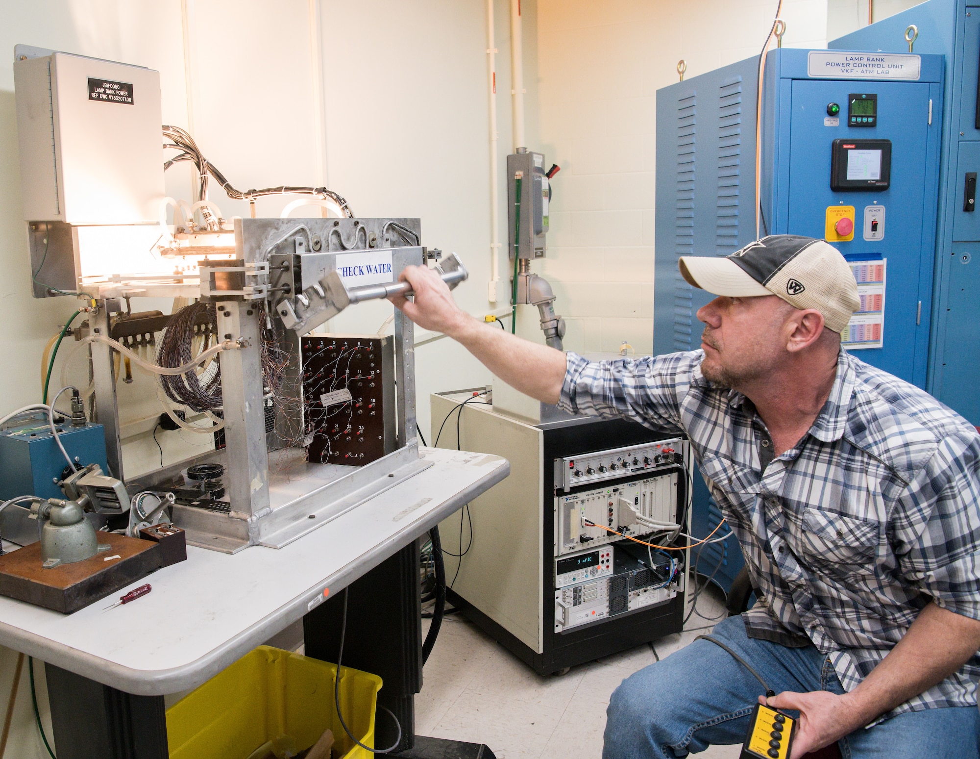 Brian Anderson, an instrumentation specialist, demonstrates the use of a machine to calibrate Schmidt-Boelter heat flux gauges Jan. 15, 2020, in the Aerothermal Calibration Laboratory at Arnold Air Force Base, Tenn. (U.S. Air Force photo by Jill Pickett)