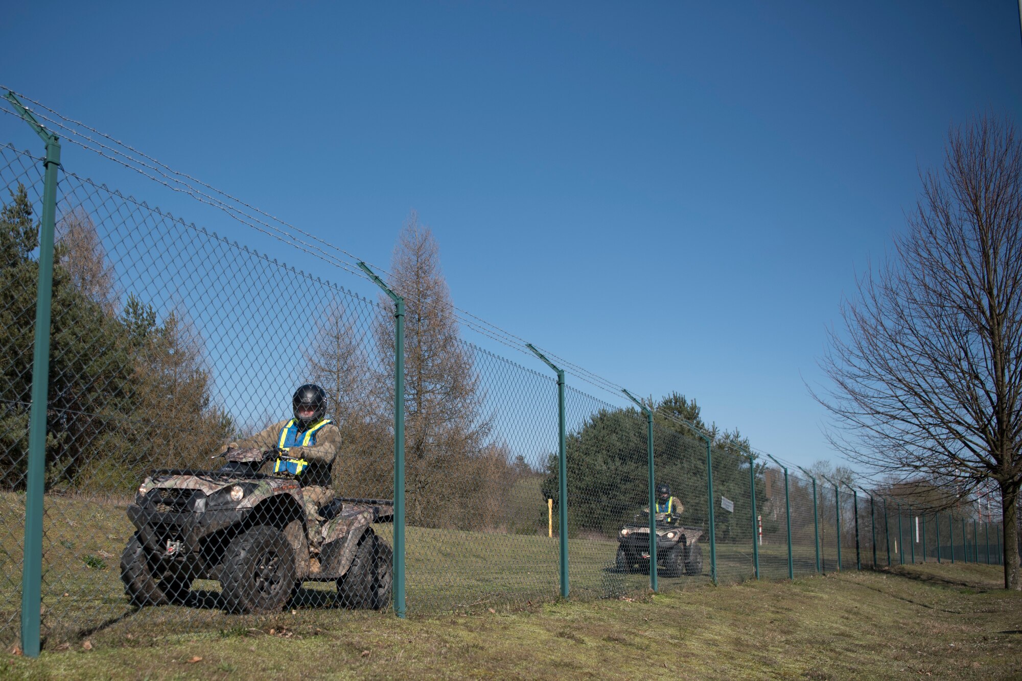 U.S. Air Force Senior Master Sgt. Jeffrey Griffith, 86th Security Forces Squadron operations superintendent, and Tech. Sgt. Andrey Shimko, 86th SFS patrolman, conduct a perimeter check using All Terrain Vehicles on Ramstein Air Base, Germany, March 24, 2020.