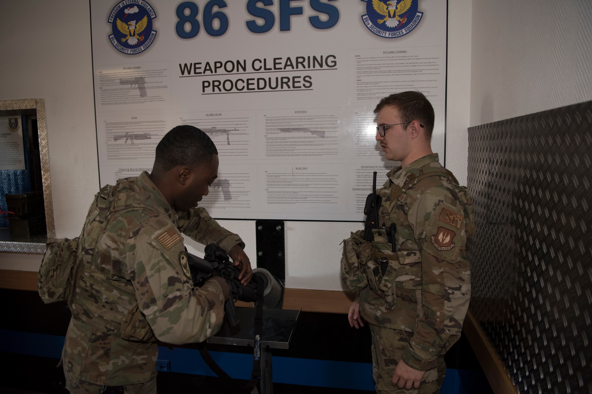 U.S. Air Force Airman Ethan Myers (right), 86th Security Forces member, verifies and authenticates the safety of a Defender’s weapon on Ramstein Air Base, March 24, 2020