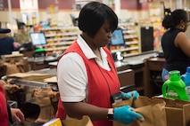 Shirley Burgohy, a head bagger at the Air Base Commissary, bags groceries at Joint Base Charleston S.C., March 24, 2020.
