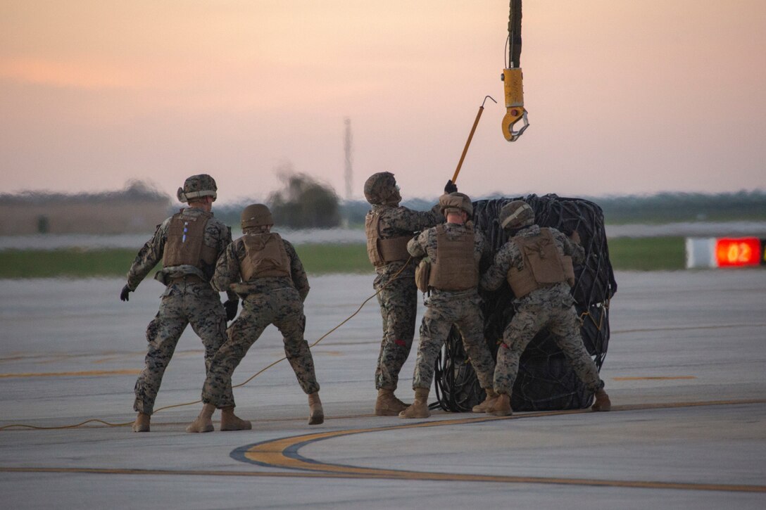 U.S. Marines with Special Purpose Marine Air-Ground Task Force-Crisis Response-Africa 20.1, Marine Forces Europe and Africa, secure a cargo bundle during external lift training at Morón Air Base, Spain, March 10, 2020. Marines conducted the training to increase helicopter support team proficiency by expeditiously moving cargo and equipment. SPMAGTF-CR-AF is deployed to conduct crisis-response and theater-security operations in Africa and promote regional stability by conducting military-to-military training exercises throughout Europe and Africa. (U.S. Marine Corps photo by Cpl. Kenny Gomez)