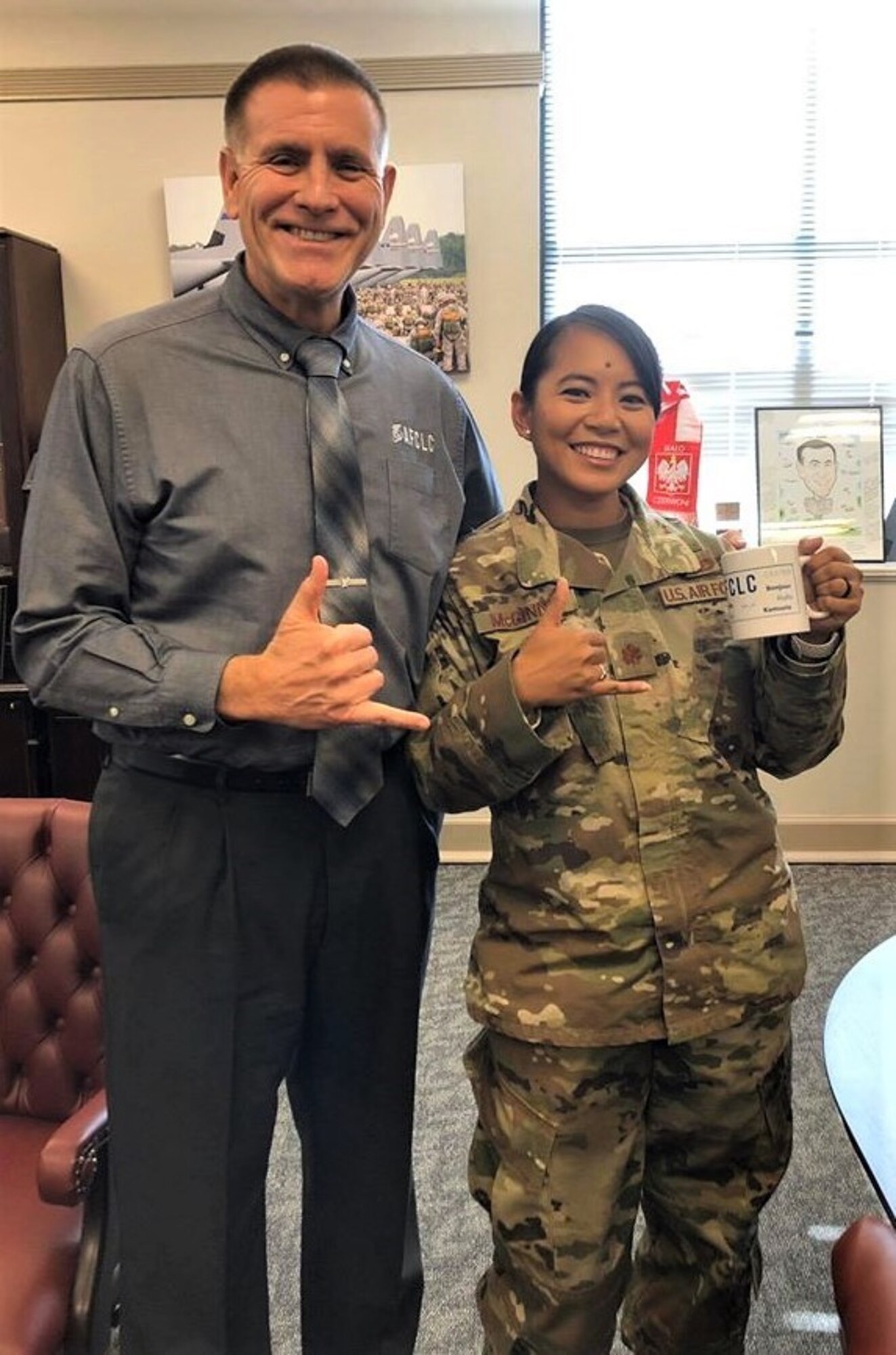 Photo caption: Major Charlynne “Char” McGinnis stops by AFCLC Director’s Howard Ward’s office