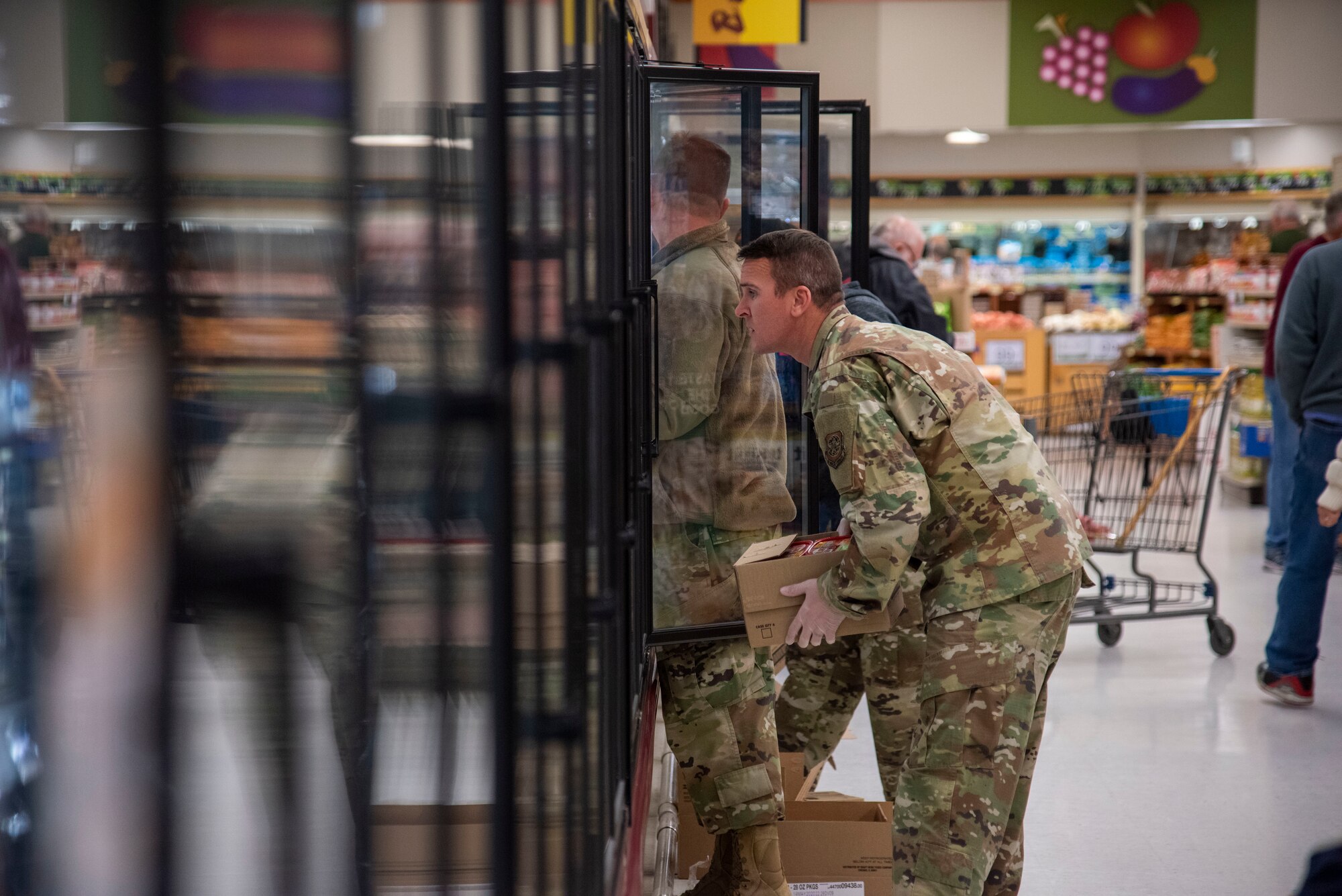 Master Sgt. Randy Walgren, 436th Maintenance Operations Squadron first sergeant, stocks frozen items at the Commissary March 25, 2020, at Dover Air Force Base, Delaware. The Chiefs Group and First Sergeants volunteered at the Commissary checking IDs, assisting with social distancing measures, and stocking shelves to help mitigate the spread of COVID-19, reduce confusion and ensure Airmen and their families still had access to essential items.(U.S. Air Force Photo by Airman 1st Class Jonathan Harding)