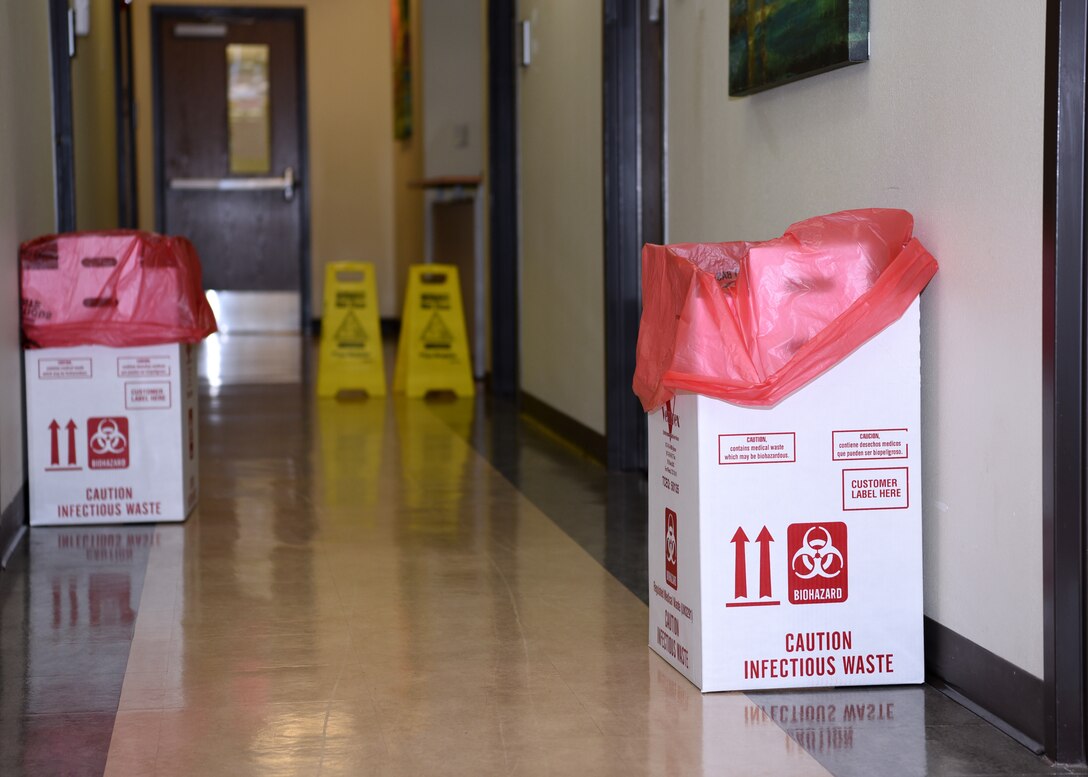 Infectious waste bins are in the CODID-19 screening hallway in the Ross Clinic on Goodfellow Air Force Base, Texas, March 25, 2020. (U.S. Air Force photo by Airman 1st Class Abbey Rieves)