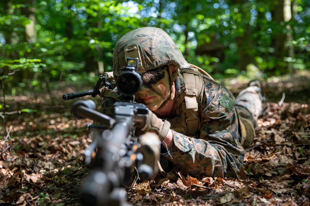 A U.S. Marine holds security with a M240B machine gun during a tactics exercise for Baltic Operations 2019.