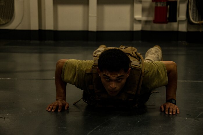 A U.S. Marine participates in a ‘Murph’ workout challenge in memory of Gunnery Sgt. Diego Pongo and Capt. Moises Navas aboard amphibious assault ship USS America (LHA 6).