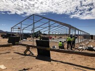 LOGCAP contractors erect a structure that will be used to quarantine for 14 days Soldiers returning from overseas deployments