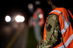 Photo of Airman awaiting vehicles.