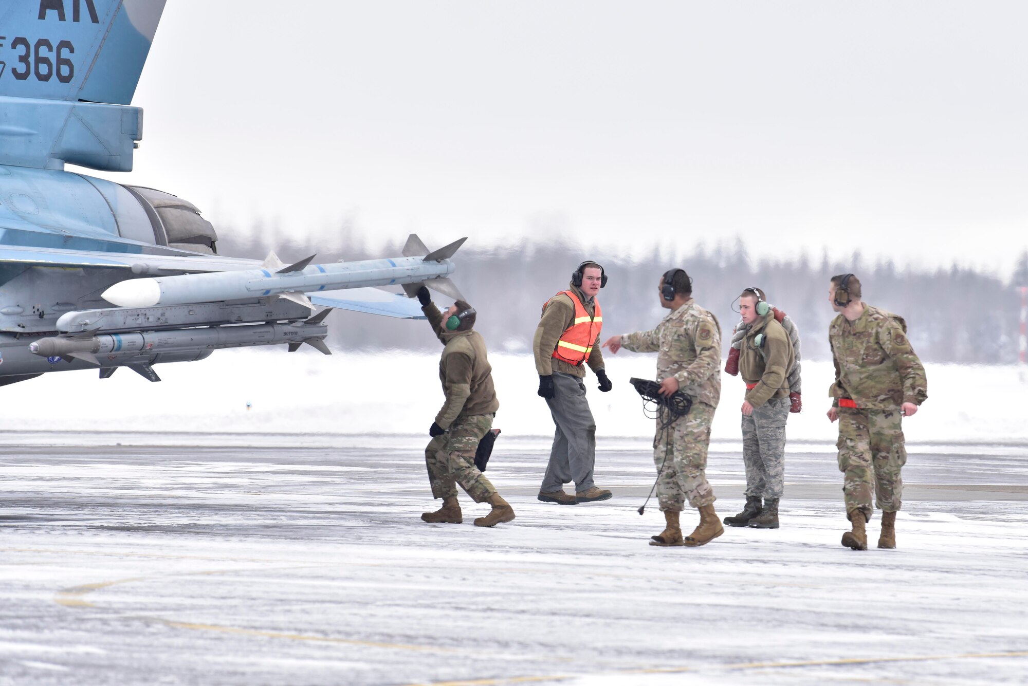 Airmen assigned to the 354th Aircraft Maintenance Squadron conduct pre-flight checks on an F-16 Fighting Falcon from the 18th Aggressor Squadron at Eielson Air Force Base, Alaska, March 24, 2020. Air Force maintainers inspect every part of the aircraft to ensure the pilot is safe and able to carry out the mission. (U.S. Air Force photo by Senior Airman Beaux Hebert)