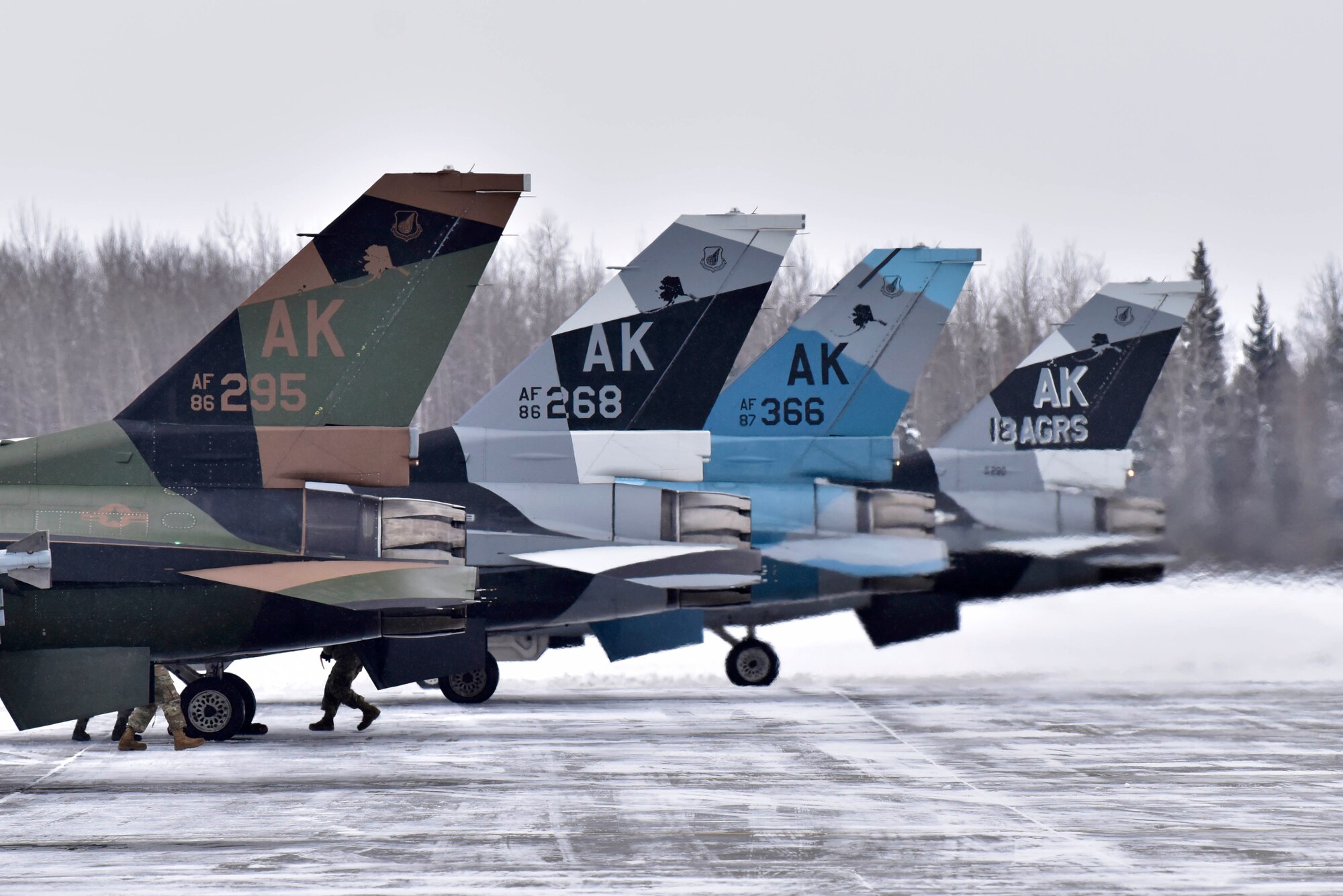 Four F-16 Fighting Falcons from the 18th Aggressor Squadron sit on the runway for final maintenance checks prior to taking off from Eielson Air Force Base, Alaska, March 24, 2020. Maintainers work around the clock to ensure the 354th Fighter Wing’s jets are always ready to execute the mission. (U.S. Air Force photo by Senior Airman Beaux Hebert)