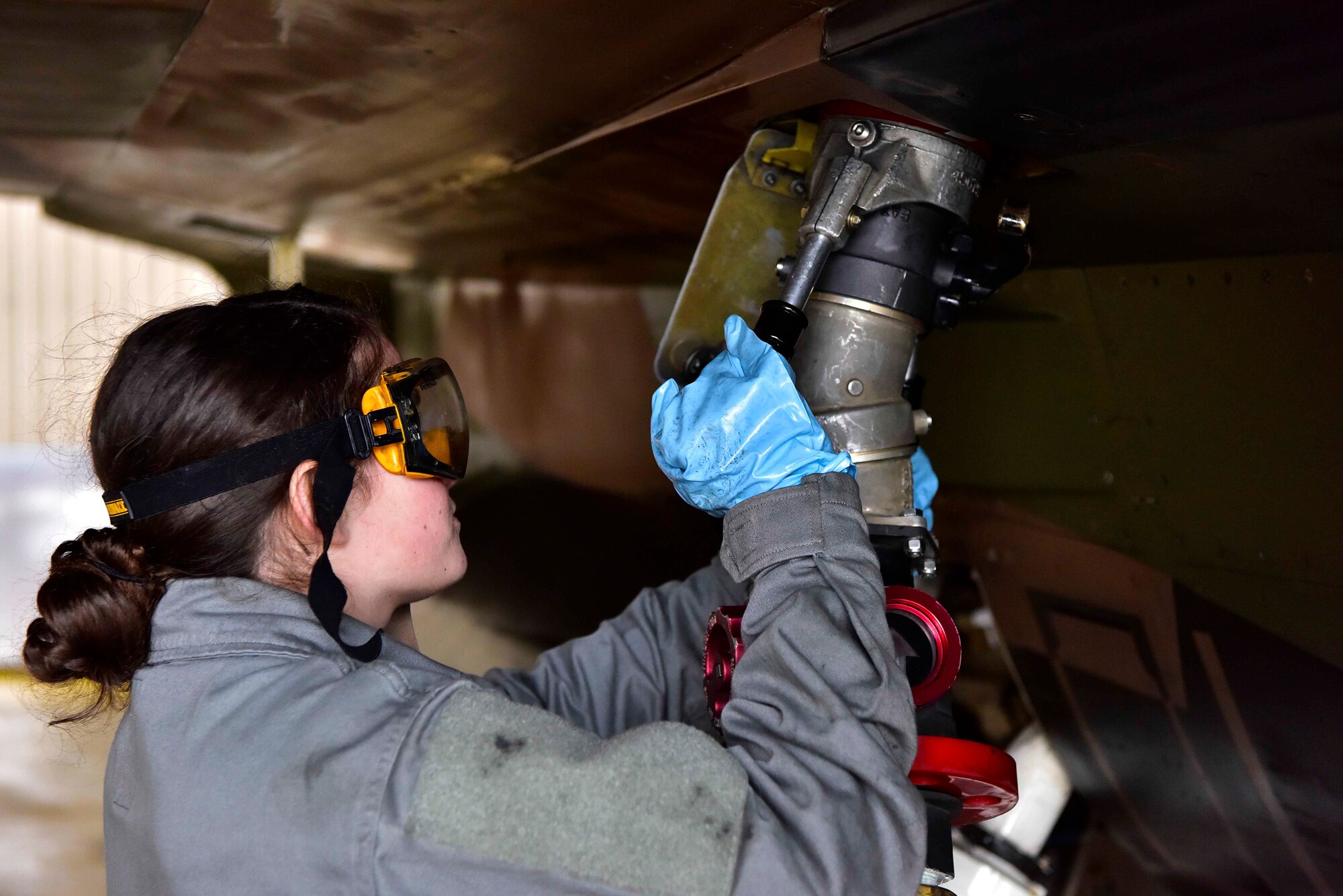 Airman 1st Class Angelia Fisher, a 354th Aircraft Maintenance Squadron crew chief, refuels an F-16 Fighting Falcon on Eielson Air Force Base, Alaska, March 24, 2020. Airmen from the 354th AMXS are following the Department of Defense policies for preventing the spread of COVID-19 while ensuring that the aircraft at Eielson are safe and ready to complete their mission. Policies include enforcing social distancing, good hygiene and personal care and sanitizing their work areas often. (U.S. Air Force photos by Senior Airman Beaux Hebert)