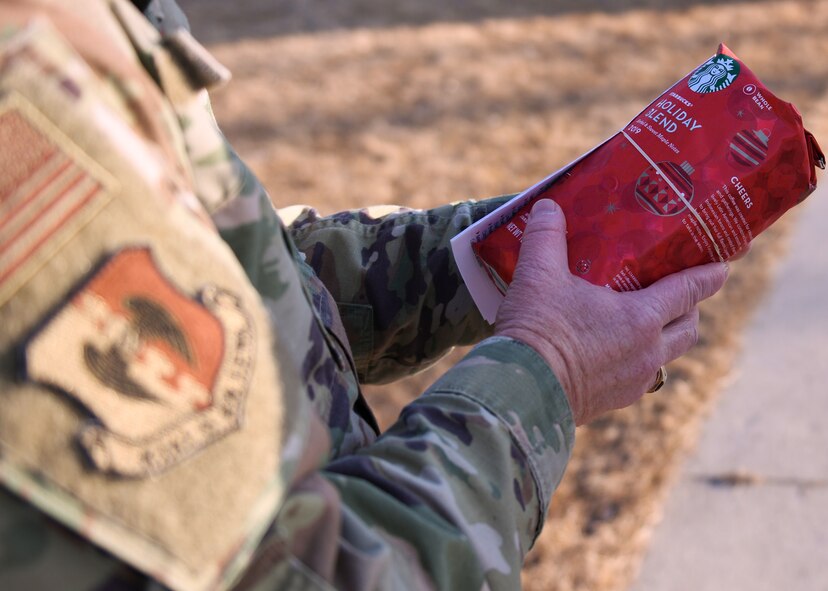 Maj. Jeffrey Lichlyter 5th Bomb Wing Chapel chaplain, holds a coffee box March 26, 2020, at Minot Air Force Base, North Dakota. Team Minot personnel donated coffee beans to Airmen and their families in need.