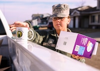 Maj. Jeffrey Lichlyter 5th Bomb Wing Chapel chaplain, holds a coffee box March 26, 2020, at Minot Air Force Base, North Dakota. Team Minot personnel donated coffee beans to Airmen and their families in need.