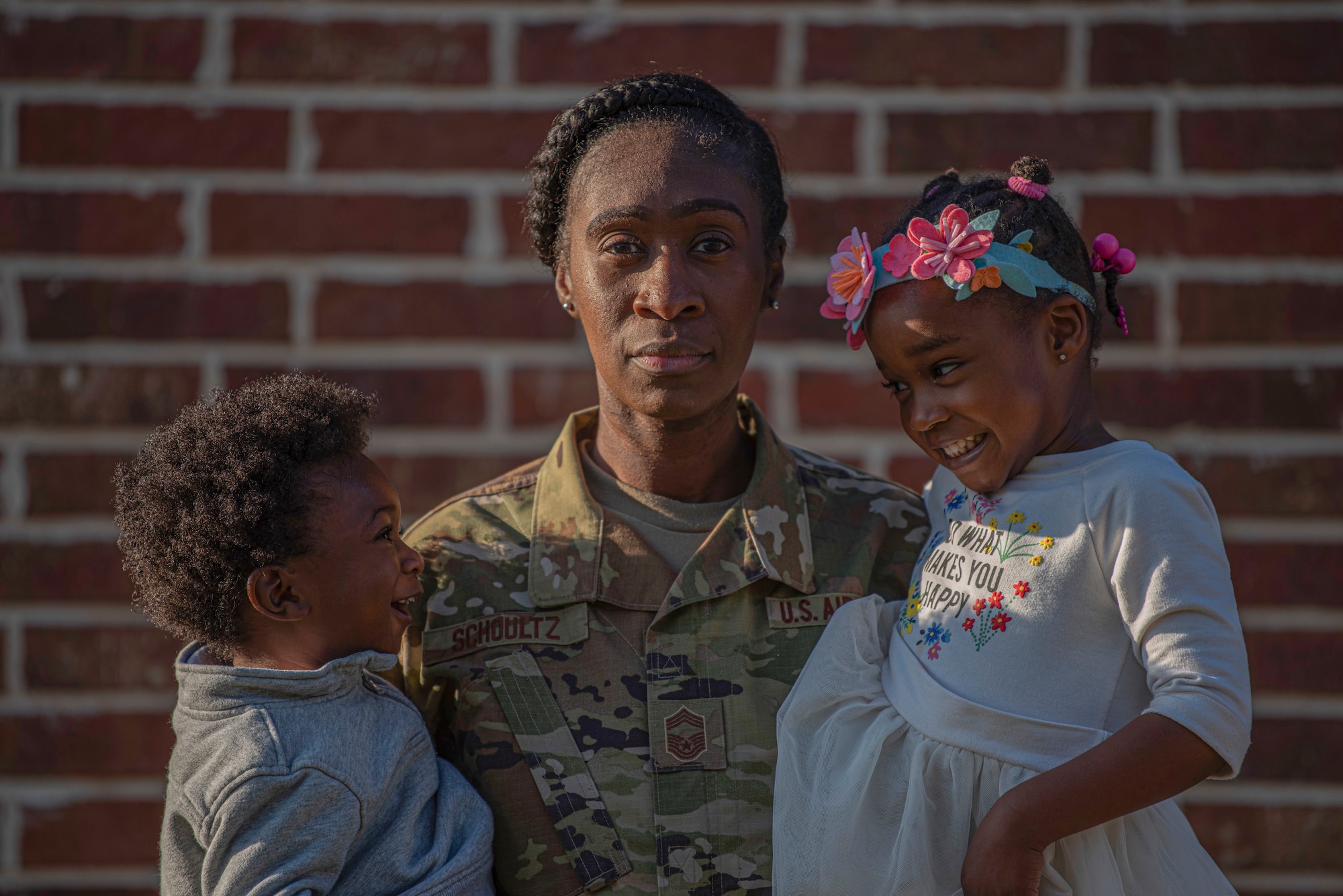 Chief Master Sgt. Latreva Schoultz, 489th Bomb Group superintendent, holds her two youngest children in Abilene, Texas, March 20, 2020. After having three sons, Schoultz adopted her daughter in the fall 2019 after fostering her for 10 months. (U.S. Air Force photo by Airman 1st Class Colin Hollowell)