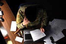 A photo of an airman working at a desk