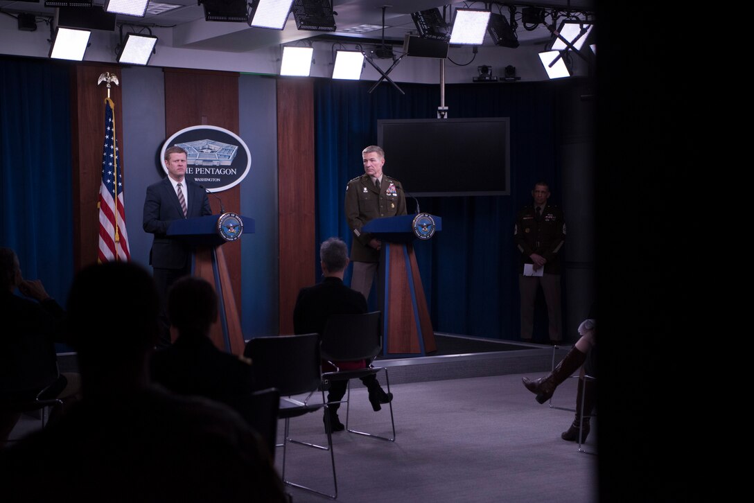 Two men stand at a podium.