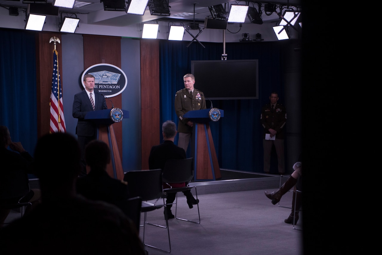Two men stand at a podium.
