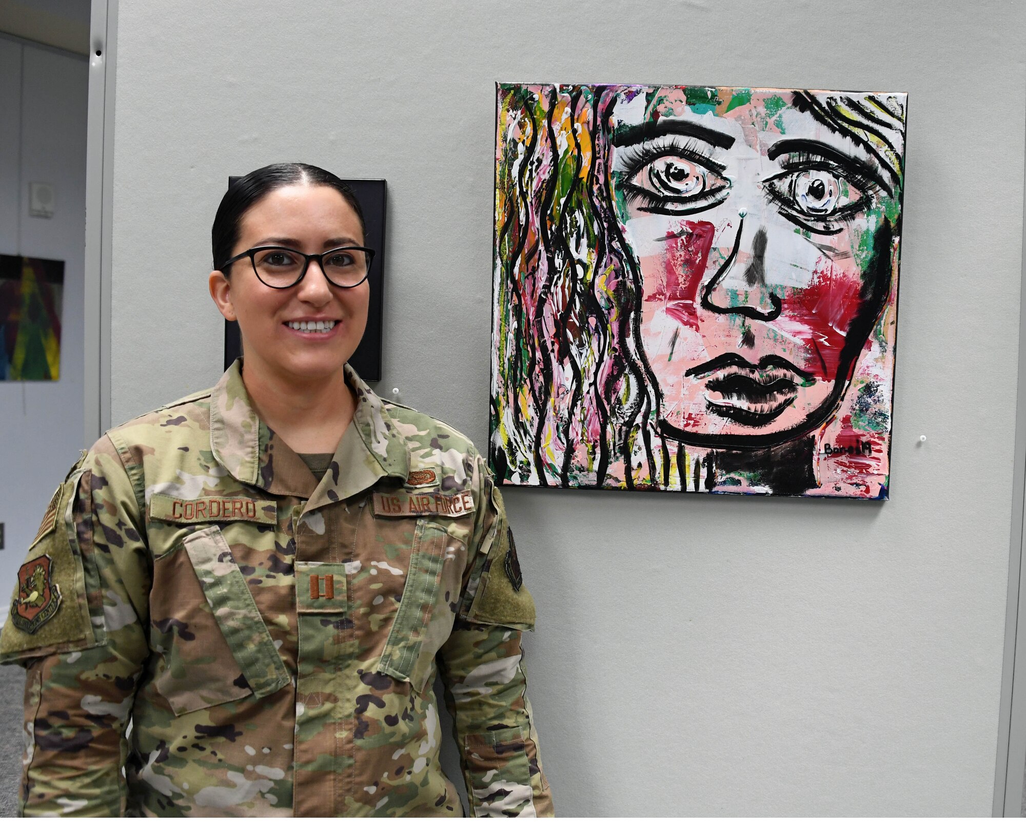 Capt. Lindsay Cordero and her painting on exhibit.
