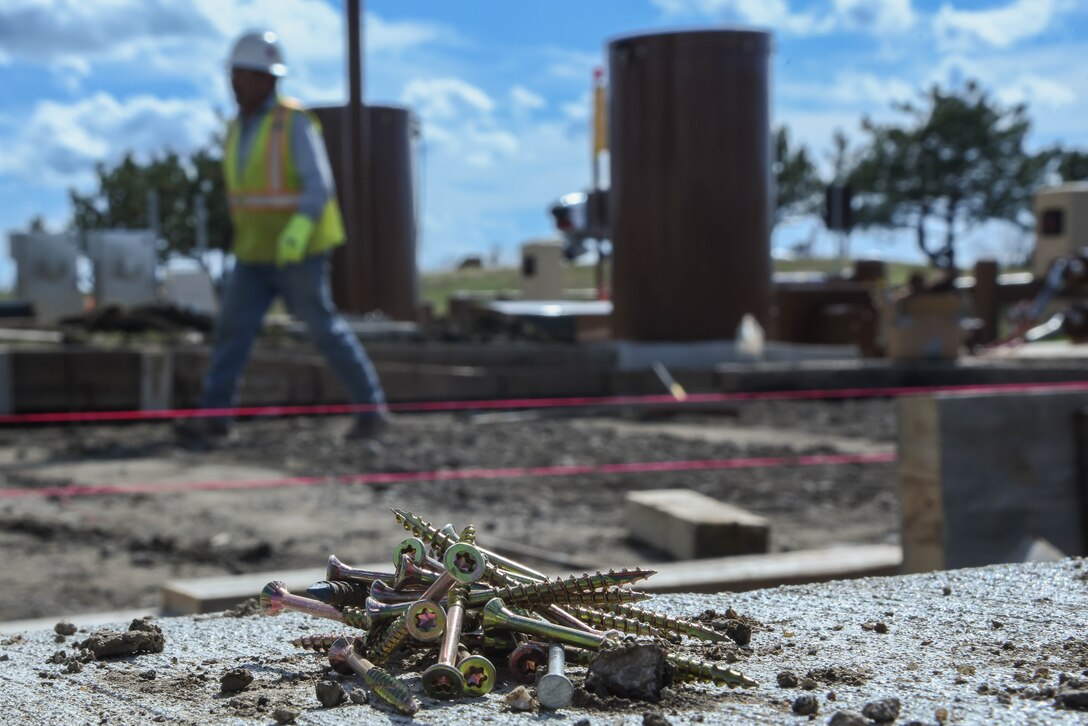 Construction workers are installing speed bumps in conjunction with the pathway to connect both air parks March 19, 2020, at McConnell Air Force Base, Kansas. The pathway is being built as a part of McConnell’s base improvement efforts to provide a walk way for Team McConnell. (U.S. Air Force photo by Airman 1st Class Marc A. Garcia)