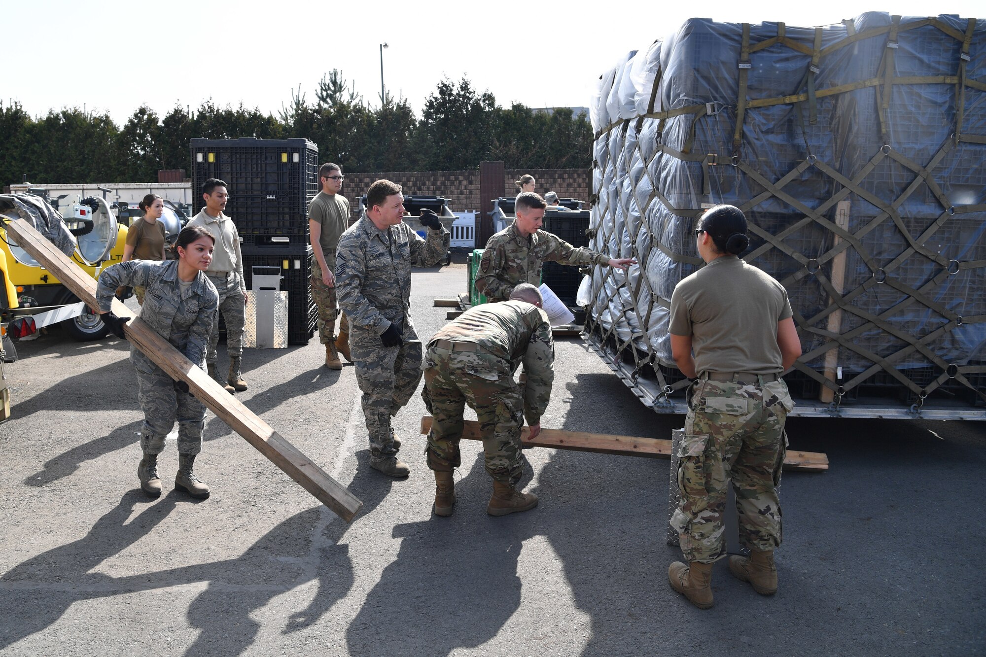 Airmen work around a pallet of medical supplies.