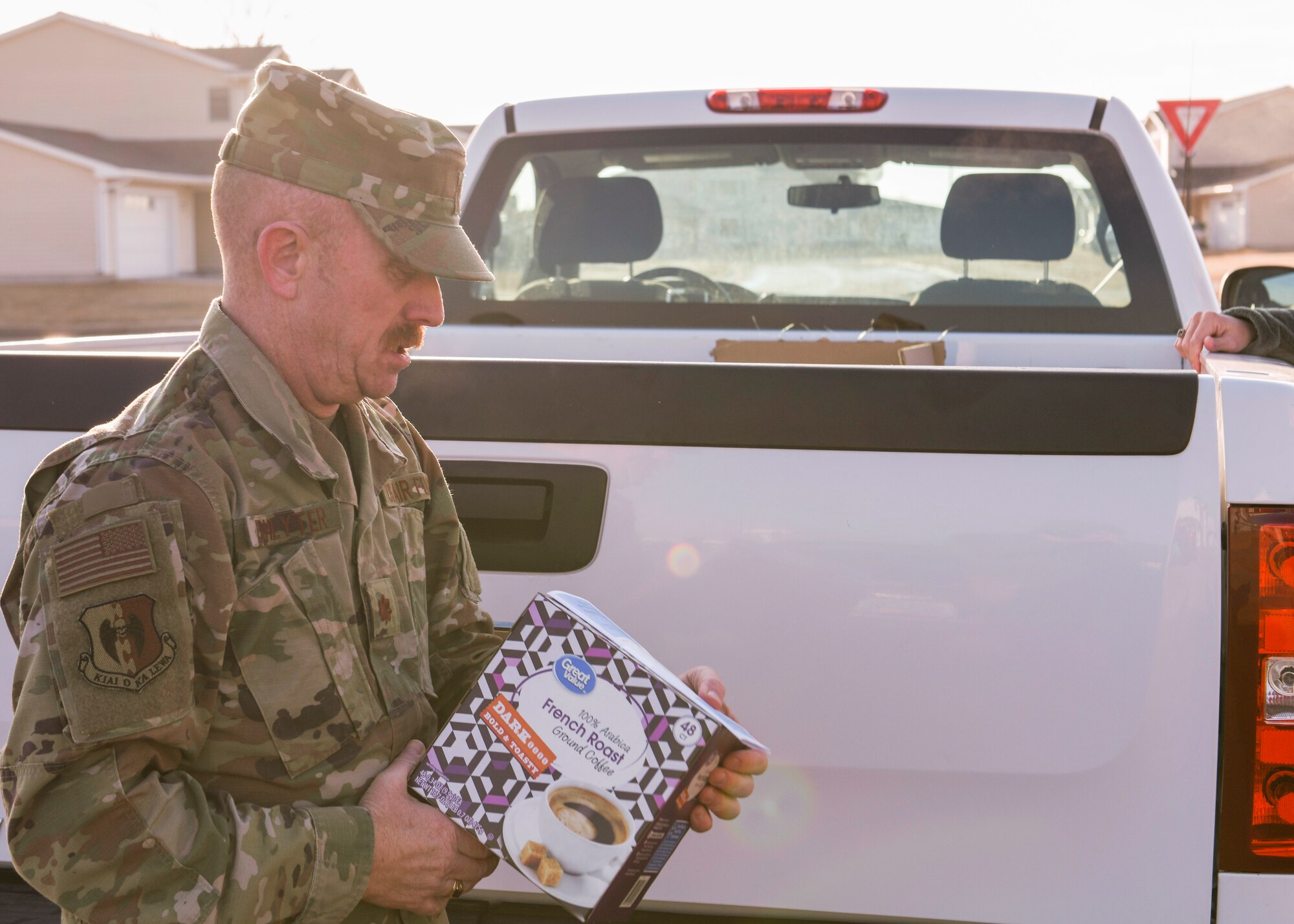 Maj. Jeffrey Lichlyter 5th Bomb Wing Chapel chaplain, holds a coffee box March 26, 2020, at Minot Air Force Base, North Dakota. Team Minot personnel donated coffee beans to Airmen and their families in need.
