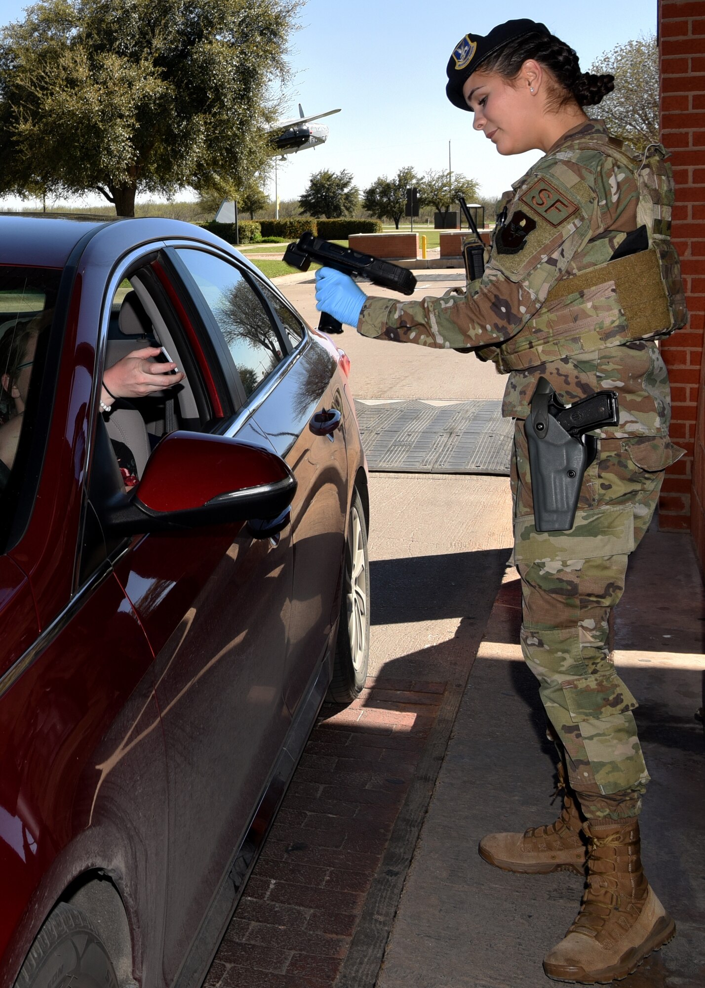 U.S. Air Force Airmen 1st Class Sandy Amezquita, 17 Security Forces Squadron installation entry controller, scans a common access card at the Jacobson Gate on Goodfellow Air Force Base, Texas, March 25, 2020. Goodfellow’s base commander declared a Public Health Emergency and limited movement for military personnel in accordance to Tier 1’s policies and procedures. Goodfellow was in Health Protection Condition BRAVO with no confirmed COVID-19 cases. (U.S. Air Force Photo by Airman 1st Class Abbey Rieves)
