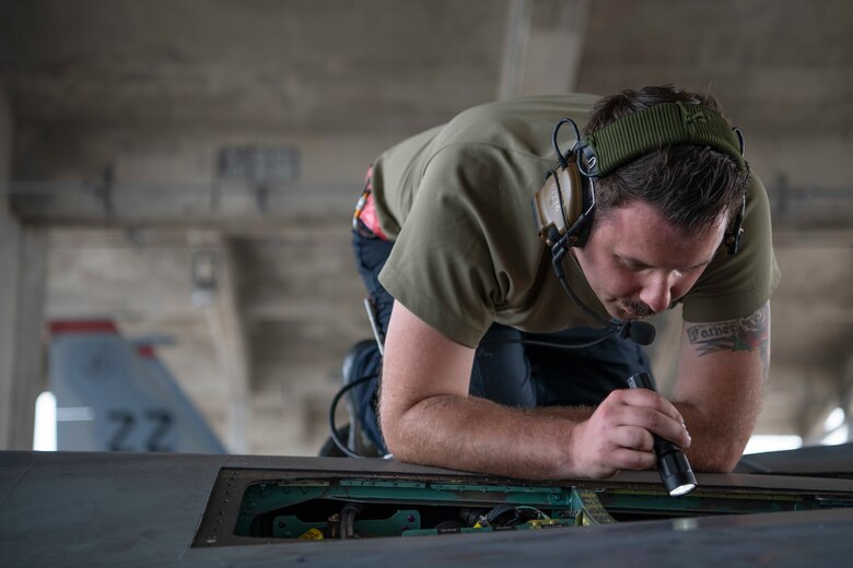 U.S. Air Force Staff Sgt. Zacharias Clemmons, 18th Aircraft Maintenance Squadron crew chief, performs a hydraulics operations check on an F-15C Eagle March 27, 2020, at Kadena Air Base, Japan. The hydraulics check is performed by running a series of tests, which simulate the same conditions likely to occur in-flight.  Airmen are working around the clock ensuring aircraft are ready for flight training operations in order to promote a free and open Indo-Pacific. (U.S. Air Force photo by Senior Airman Rhett Isbell)