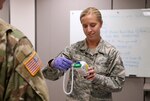 Staff Sgt. Mariah Klingenberg, a force support squadron Airman with the 132d Wing, Iowa Air National Guard, reads a Soldier’s temperature before they enter the Joint Emergency Operations Center March 26, 2020. Iowa National Guard Soldiers and Airmen who are on state active duty to support COVID-19 response efforts must have their temperature taken before reporting for work to slow the spread of COVID-19 and protect the health of Iowa National Guard members.