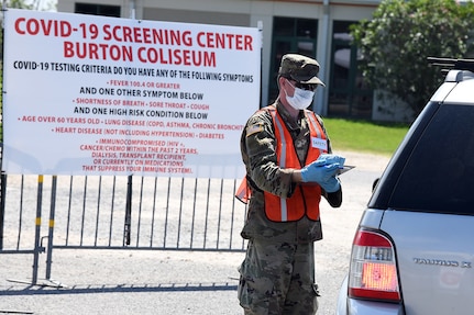 Pvt. Pat Dawsonhassell, a 20-year-old Lake Charles resident with Headquarters and Headquarters Company, 3rd Battalion,156th Infantry Regiment, 256th Infantry Brigade Combat Team, screens patients at a COVID-19 mobile testing site at Burton Coliseum in Lake Charles, Louisiana, March 26, 2020.