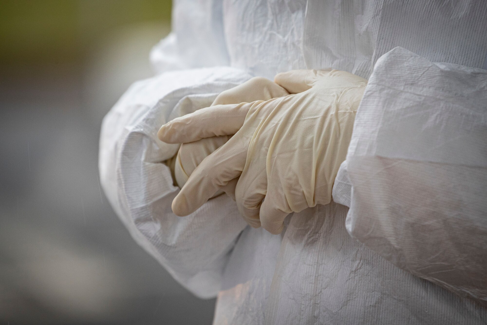 A medical technician adjusts her gloves at a COVID-19 Community-Based Testing Site at the PNC Bank Arts Center in Holmdel, N.J., March 23, 2020.  The testing site, established in partnership with the Federal Emergency Management Agency, is staffed by the New Jersey Department of Health, the New Jersey State Police, and the New Jersey National Guard.