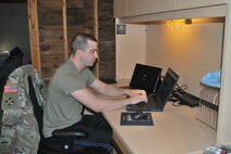 A makeshift office in his basement allows Staff Sgt. Andrew Menard, to continue recruiting for the force.