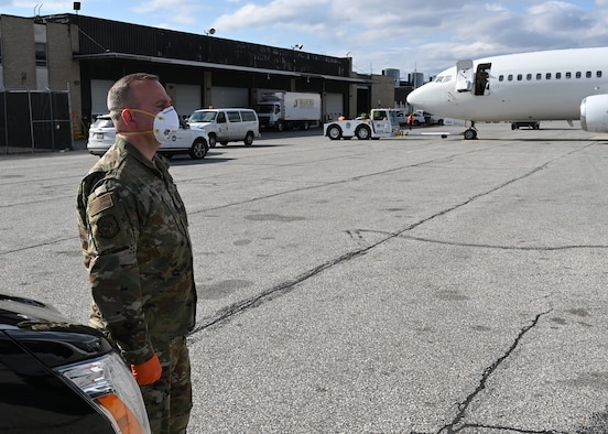 U.S. Air Force Master Sgt. William Hohman, 275th Cyberspace Operations Squadron, Maryland Air National Guard, stands ready at Baltimore Washington International Airport, March 17, 2020, before transporting passengers from the Grand Princess cruise ship who have been quarantined due to the novel Coronavirus (COVID-19) pandemic. The Maryland National Guard has activated 1,000 personnel with another 1,200 Airmen and Soldiers ready at an enhanced state of readiness. (U.S. Air National Guard photo by Master. Sgt. Chris Schepers)