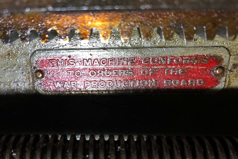 An identification plate identifies a machine.