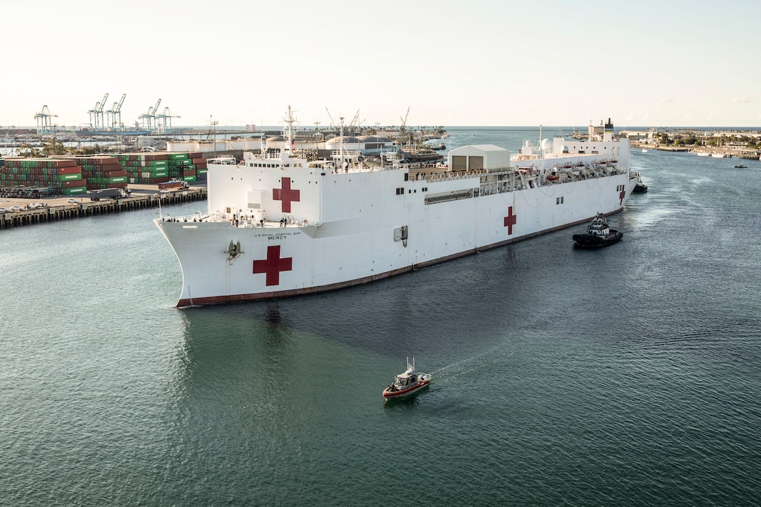 A hospital ship arrives at a port.